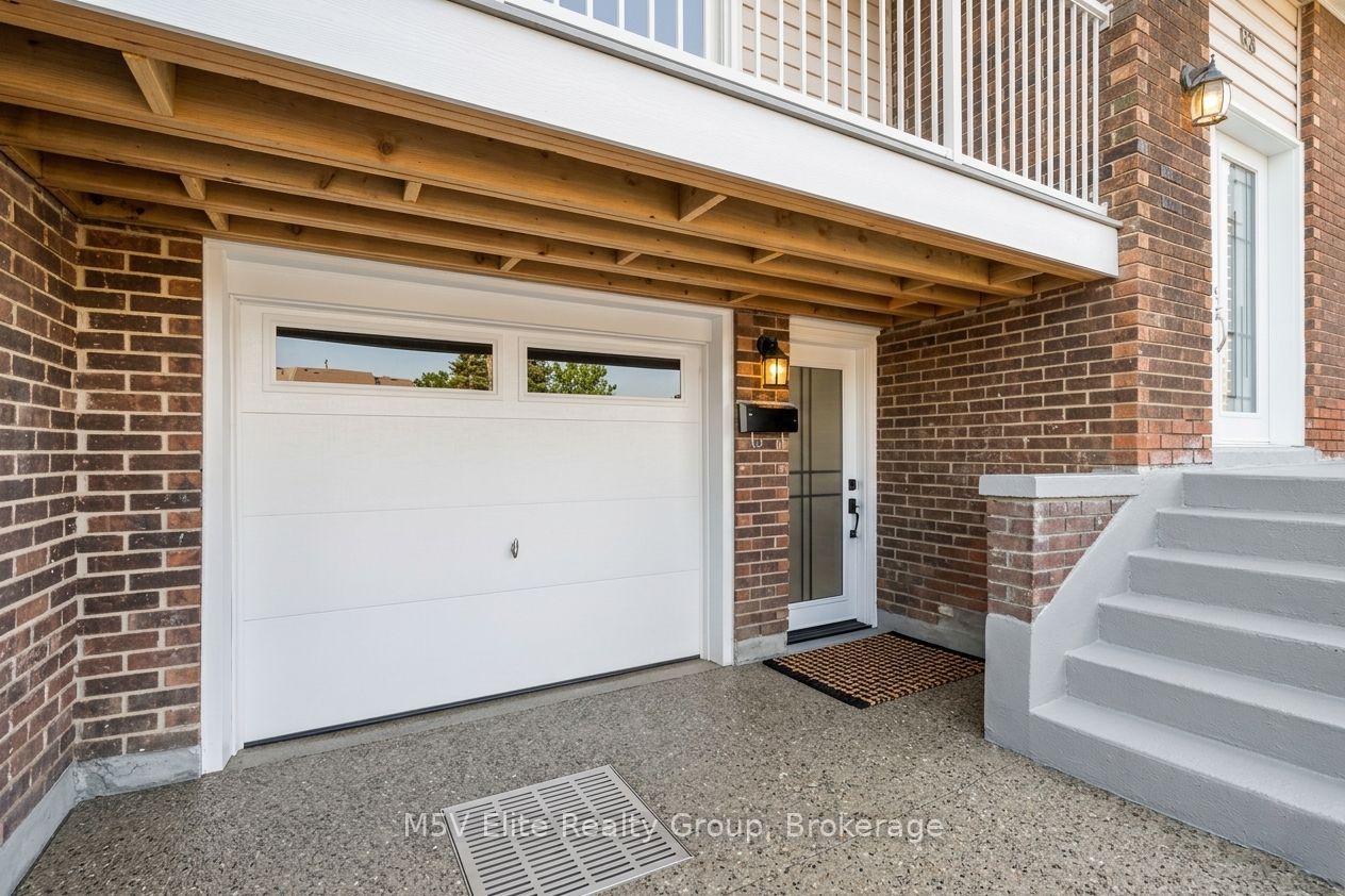 Private walkout entrance with covered porch